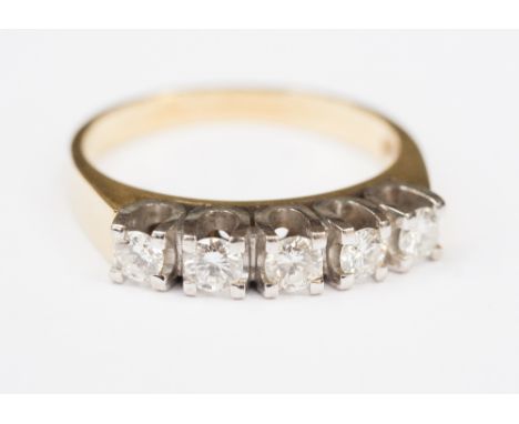An 18k gold diamond ring.