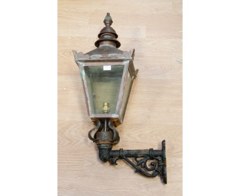 A building mounted street gas lamp on cast right angle bracket, converted to electric circa 1900 