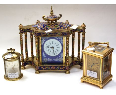 Three clocks, one carriage, one travel and another enameled mantel clock, complete with key