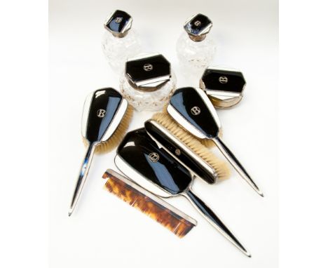 A sterling silver Art Dec dressing table set to include hand mirror, three brushes, dressing table jar and cover, two scent b
