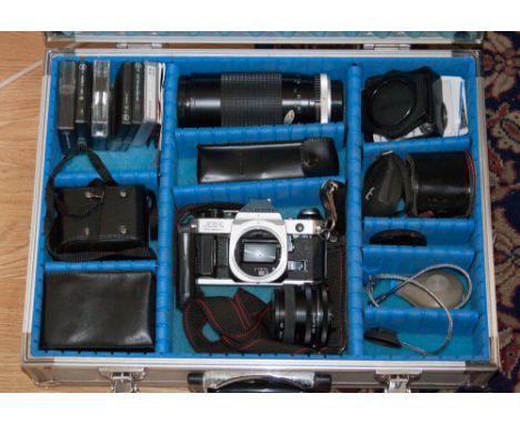 A canon AEI camera with lens and paver winder, filters, light meters etc, in original silvered metal case, instruction manual