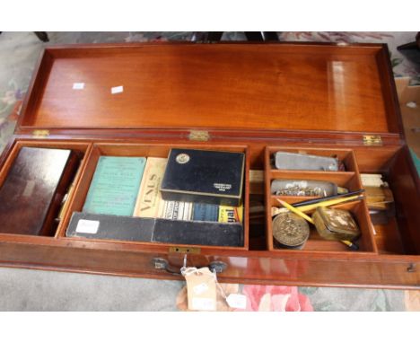 An Edwardian mahogany draughtsman box, with three internal sliding trays, containing various rulers, slide rules, pencils, pe