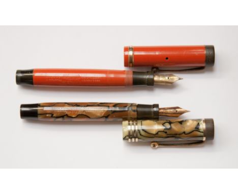 Two Parker Duofold junior fountain pens, first red single broad band, circa 1927, clear imprint, second de luxe pearl and bla