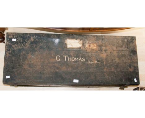 A vintage black painted tin trunk, the lid painted 'G THOMAS Royal navy'.