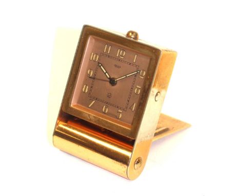 An Art Deco Jaeger travel alarm clock, rose gold plated, rectangular form with 2 inch square dial and fluorescent Arabic nume