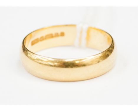 An 18ct yellow gold plain wedding ring, 5mm wide, weighing approximately 4.3 grams.