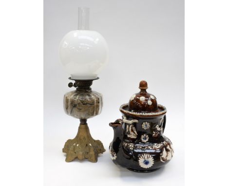 A Barge Ware tea pot, decorated with flowers and birds, along with glass oil lamp (af) 