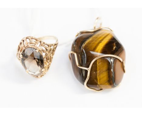 A 9ct ring set oval faceted brown stone and a tiger's eye pendant.