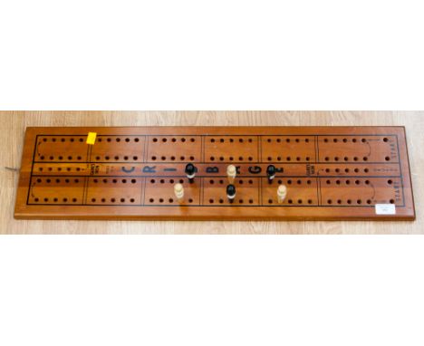 A cribbage board, model 1010; together with six pegs, three ebony, three beech 