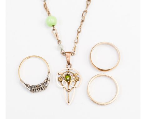 Two 9ct wedding bands, a three stone diamond ring and an Edwardian 9ct openwork pendant, set peridot, on costume necklace.