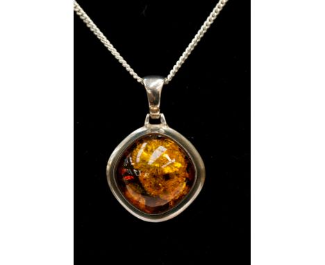 An amber pendant (silver surround) and chain 