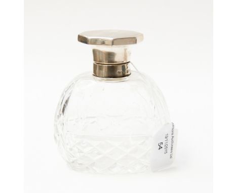 A cut glass cologne bottle with octagonal silver top, engine turned decoration, complete with fitted stopper, Birmingham 1940