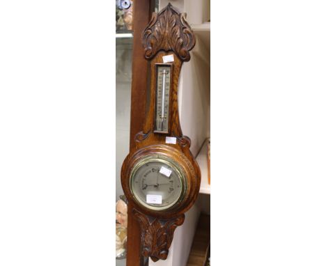 A Victorian oak wheel barometer with thermometer 