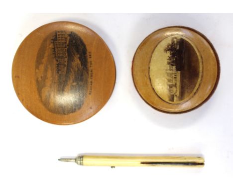 Two Mauchline ware items including Lowther Castle pin cushion and Redgar form the Sea; together with an ivory propelling penc