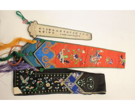 Three embroidered waist band ties, a pair of black ground trims and an embroidered chop stick holder. (5)