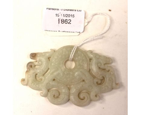 A Chinese carved jade pendant with two dragons 