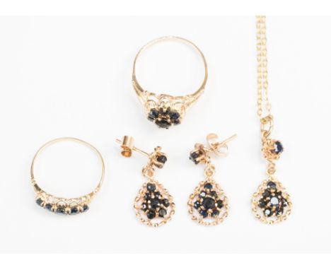 A 9ct sapphire cluster ring, 9ct five stone sapphire ring and a pair of 9ct sapphire drop earrings and pendant en suite.