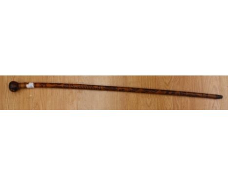 A late 19th/early 20th Century walking cane, knob finial, the shaft lightly carved and stained with Giraffe, Elephant, Camel,