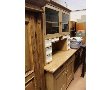 A Victorian style pine glazed kitchen cabinet, the upper section with two glazed doors opening to reveal a single shelf, with