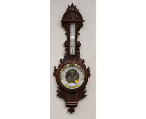 A Late Victorian heavily carved mahognay barometer and thermometer, with foliate carving, with inscription, September 17th 18