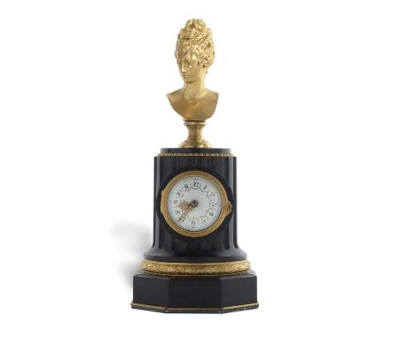 An unusual 19th Century French mantel clock of column form set with a gilt metal bust over a ribbed column with small enamel 