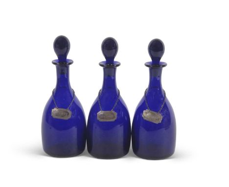 A group of three late 19th/early 20th Century Bristol blue glass decanters with ball stoppers and silver labels for Sherry, W