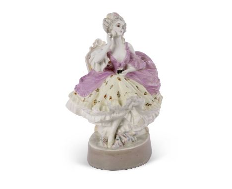 A large Goldscheider model of a lady with a flounced skirt on an oval base