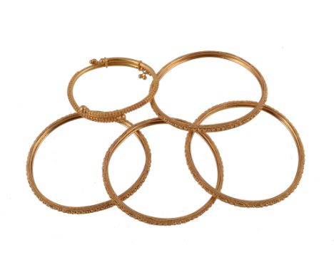  Four bangles,   with heart and bead detail, 5.7cm inner diameter; and a smaller similar bangle, 4cm inner diameter, 67.8g 