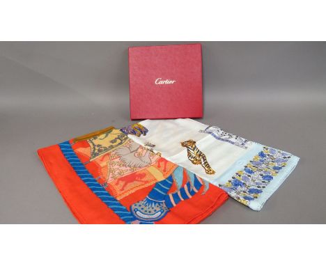 A Cartier silk scarf,in light cream and pale blue, with Cartier jewellery to the centre, in original Cartier box,together wit