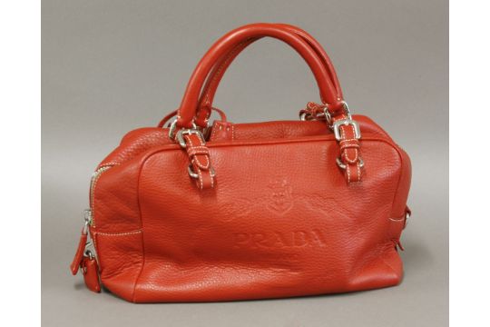 A Prada Red Leather Handbag With Embossed Milano Logo Design A Prada Red Leather Handbag With Embossed Milano Logo Design Cream Fabric Lining And
