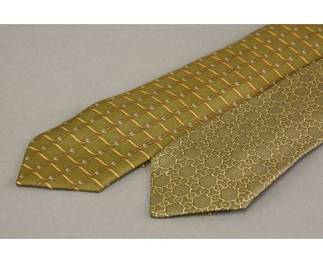 Two Hermès silk ties,to include a khaki-green example with belt design, anda light brown with link pattern tie (2)