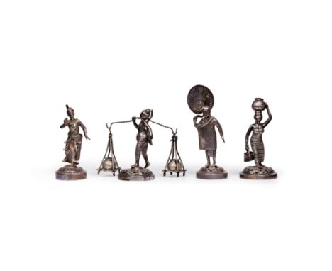 Four Burmese silver figures20th centuryEach figure wearing traditional dress, cast standing on an openwork chased foliate scr
