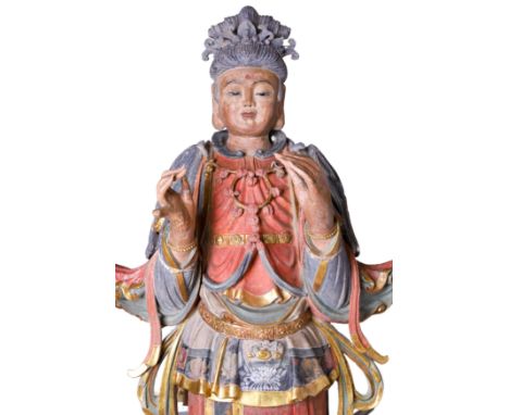 A monumental Chinese polychrome and gilt stucco figure of GuanyinEarly Ming dynastyThe tall figure raised on lotus pedestal, 