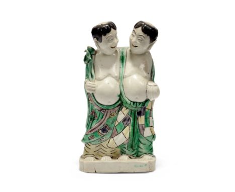 A Chinese famille verte on biscuit figure group of the Hehe ErxianQing dynasty, Kangxi periodThe twins modelled wearing flowi