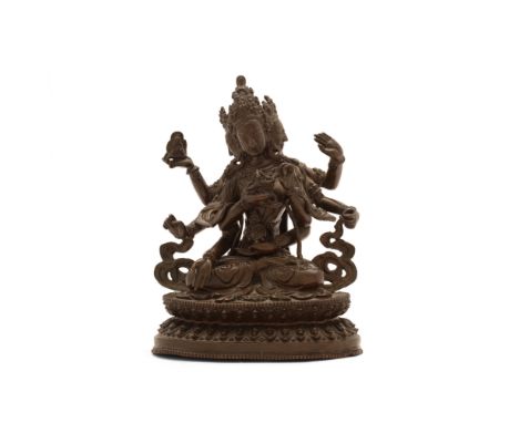 A Tibetan bronze statue of Uṣṇīṣavijayā19th centuryThe three-headed goddess seated on a lotus pedestal, holding a double vajr