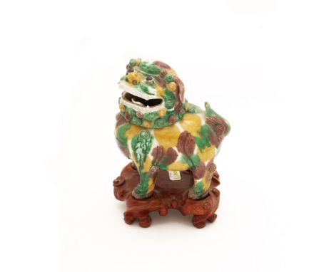 A Chinese sancai on biscuit 'Buddhistic lion' incense burnerQing dynasty, Kangxi periodModelled standing with head raised and