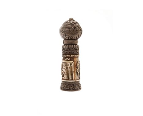 A Tibetan silver and bone seal19th centuryThe finial set with a turquoise cabochon and repoussé decorated with a mythical bea