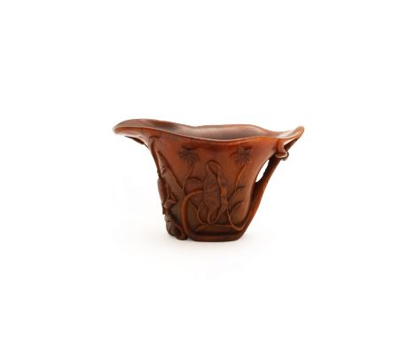 A Chinese rhinoceros horn 'lotus' libation cupQing dynasty, Kangxi periodFinely carved and pierced as an oversized lotus leaf
