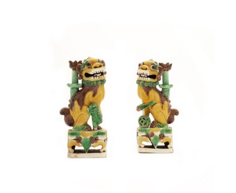 A pair of Chinese famille verte on biscuit Buddhistic lion incense holdersQing dynasty, Kangxi periodEach modelled with one f