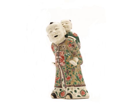 A Chinese famille verte on biscuit 'piggyback' groupQing dynasty, Kangxi periodThe older brother wearing a robe decorated wit