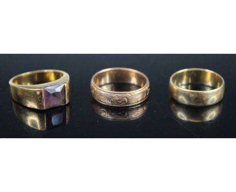 A 9ct gold wedding band, with carved decoration, size O; together with a plain 9ct gold wedding band, 6.5g; and a modern gilt