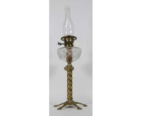 A 19th century brass oil lamp, having a clearcut glass font and spiral brass stem, h.71cm (lacking shade)Nibble chips to chim