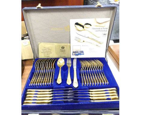 A modern German gold plated 12-place setting canteen of cutlery, in a leather briefcase 