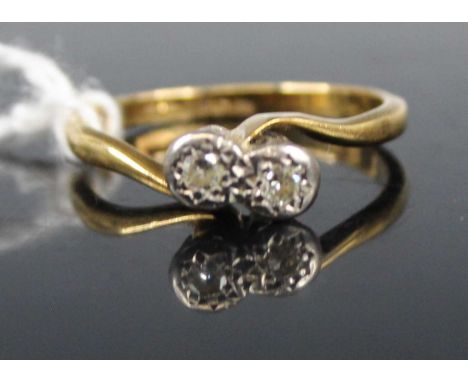 An 18ct gold diamond crossover ring, arranged as two small illusion set round cuts, size M, 2.8g