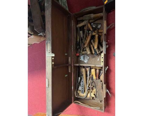A large wooden box containing various tools 