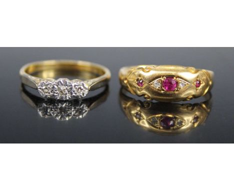 An 18ct gold and platinum, diamond three-stone ring, arranged as three small illusion set round cuts, size O; together with a