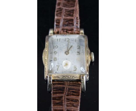 An Art Deco gold plated tank wristwatch, having unsigned silvered Arabic dial, manual wind movement, case w.2.8cm, on leather
