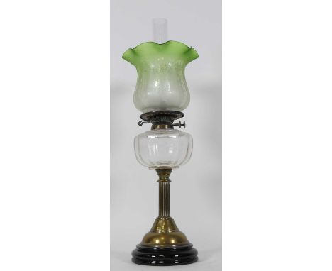 A Victorian brass oil lamp, having an acid etched green tinted glass shade and clear glass font, h.63cm. NO POSTAGE COLLECTIO