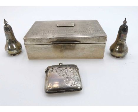 A George V silver clad table cigarette box of typical hinged rectangular form having engine turned cover and cedar lined inte