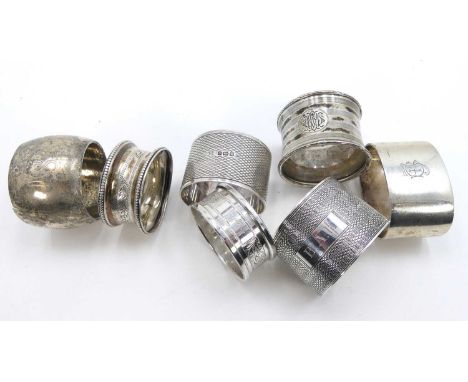 A George V silver napkin ring, having all over engine turned decoration, and monogrammed cartouche, together with six other s